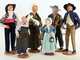five figurines of people standing in a line