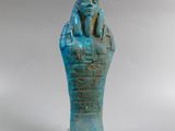 an egyptian blue glazed statue of a pharaoh