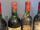 four bottles of wine are lined up on a table