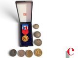 a small box with coins and a medal in it