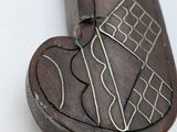 a wooden stick with a metal design on it