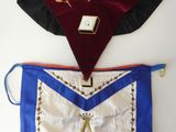 a close up of two masonic aprons hanging on a wall