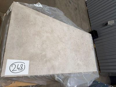 a cardboard box sitting on top of a pile of boxes