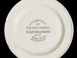 a white plate with black writing on it on a black background