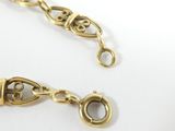 a close up of a gold chain with a clasp on it