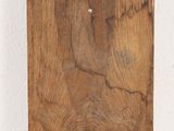 a wooden cutting board with a piece of wood sticking out of it