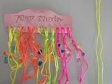 a bunch of neon colored hair ties hanging on a wall