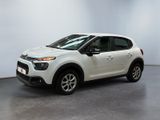 the white car is parked in a large room with white walls