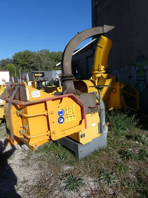 a yellow machine that is sitting in the grass