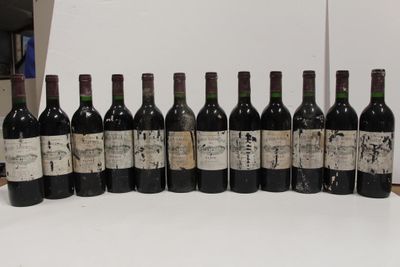 several bottles of wine are lined up in a row on a table