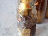 three bottles of wine wrapped in plastic on a table