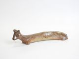 a small figurine of a small animal on a white surface