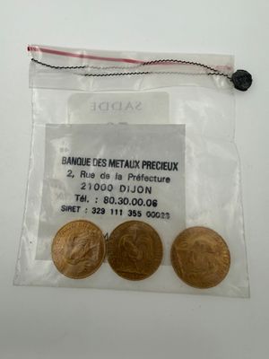 a close up of three coins in a bag on a table
