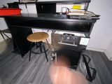 a black desk with a stool in front of it