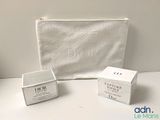 the contents of a white cosmetic bag and a white cosmetic bag on a table
