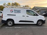 the white van is parked in the parking lot near the building