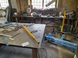 a workbench with tools on it in a workshop