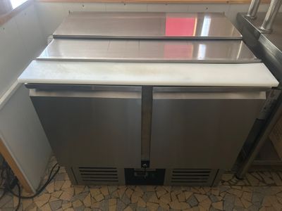 a stainless steel refridgerator in the corner of a kitchen