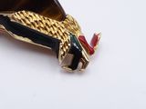a picture of a brooch with a snake on it