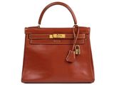 a brown leather handbag on a white background