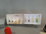 three bottles of perfume in a display case on a table