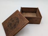 a small wooden box with a flower design on it