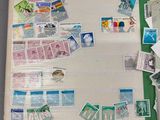 a white board covered with stamps and pictures on it