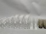 a lot of glasses that are sitting on the table