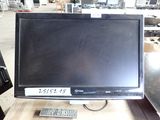 a computer monitor sitting on top of a wooden table