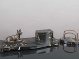 a statue of a dog sitting on top of a marble desk
