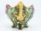 a vase with a giraffe inside of it on a white surface