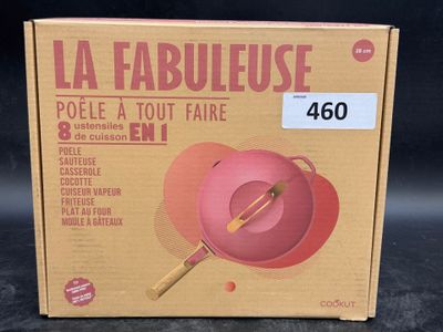 a box that has a pink bowl and a wooden spoon in it