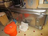 an image of a kitchen with a trash can and a trash can