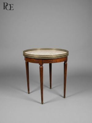 a small round table with a marble top and wooden legs