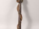 a close up of a wooden stick with a tree on it