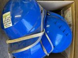 two blue hard hats in a box on the floor