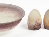 three pieces of pottery sitting next to each other on a white surface