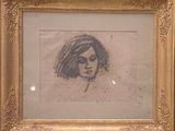 dessin représentant le visage d'une femme dans un cadre doré