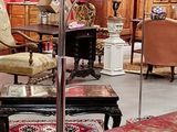a room with a lot of furniture and a red wall