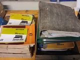 many boxes of mail sitting on a cart in a garage