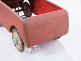 a red toy truck that is sitting on a white surface