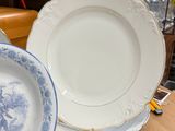 many plates that are sitting on a wooden table