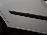 a small white car parked in a parking lot