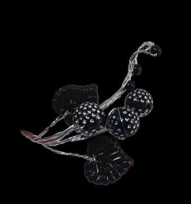 silver and black flower broochle on a black background