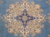 a blue rug with a floral design on it