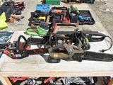 several chainsaws and other tools are on a table