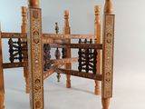 a wooden table that has a wooden structure on top of it
