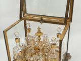 a glass case with a lot of glasses inside of it