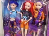 three dolls of different colors are in a box on a table
