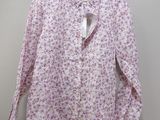the shirt is pink and has a floral pattern on it